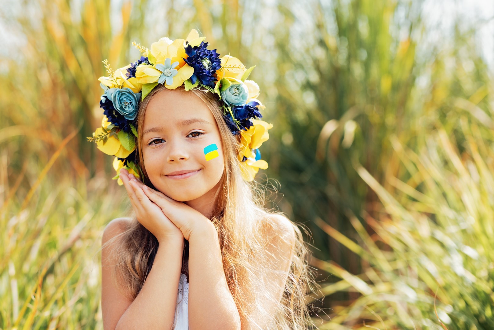 Ukrainian child girl with yellow and blue flag of Ukraine. flag symbols of Ukraine. Family, unity, support. Ukrainians are against war.